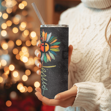 Load image into Gallery viewer, Side angle of Bloom in Faith™ tumbler showing vibrant multicolor floral cross artwork on a black background.