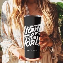 Load image into Gallery viewer, Front view of Light of the World™ Tumbler inspired by Matthew 5:14 with bold white typography on black background.