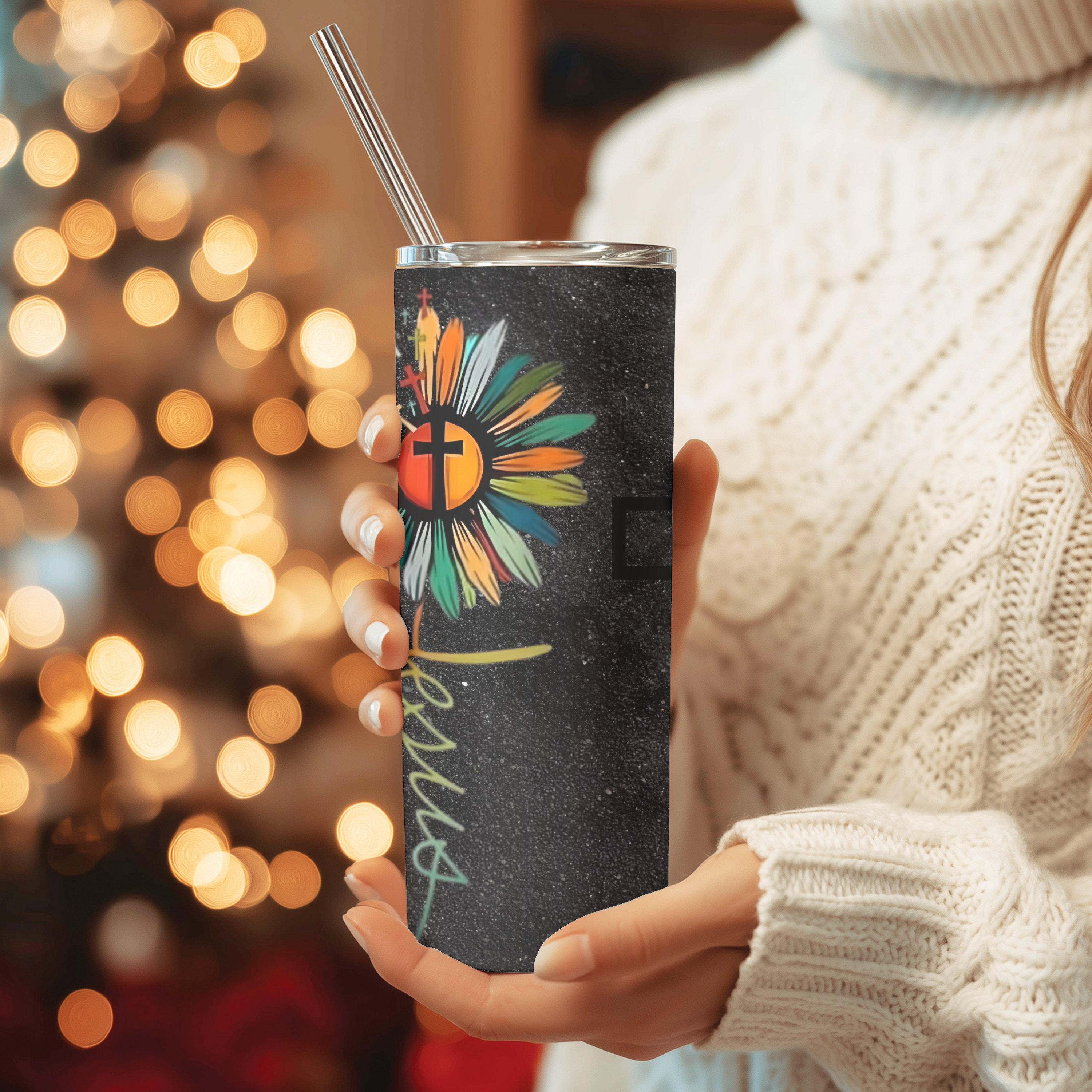 Side angle of Bloom in Faith™ tumbler showing vibrant multicolor floral cross artwork on a black background.