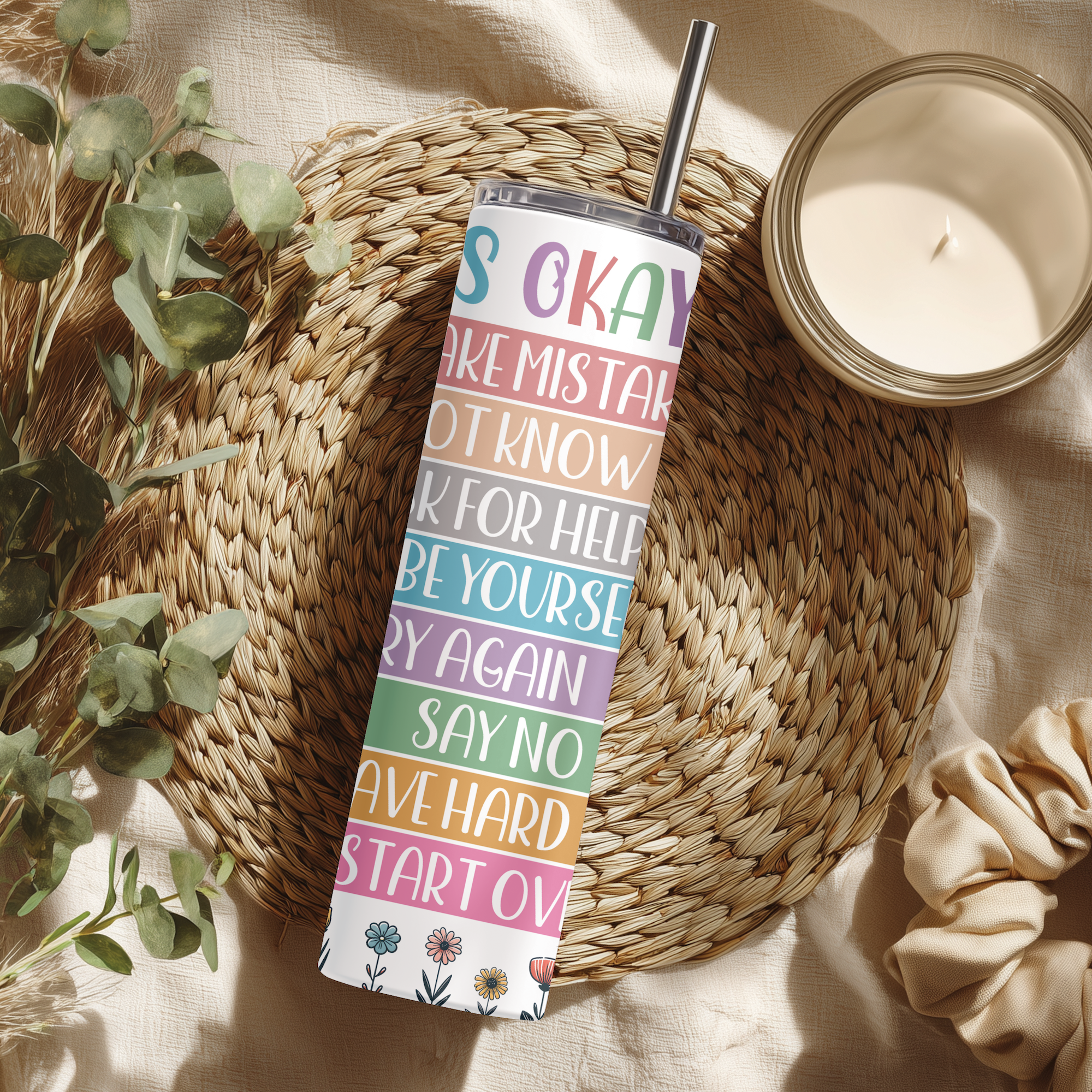 Lifestyle photo of It’s Okay tumbler styled with books and journal.