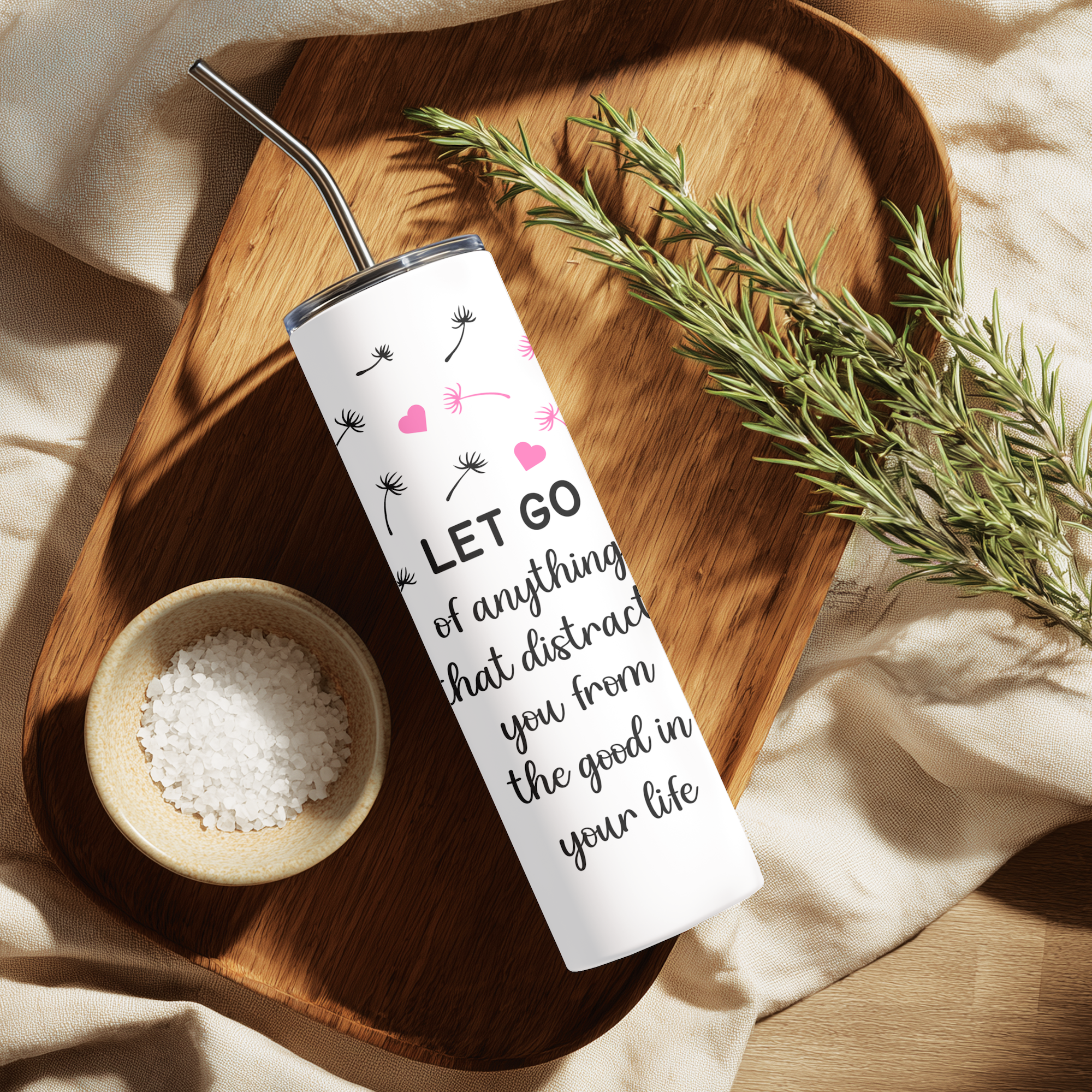 Lifestyle photo of Let Go tumbler on a reflective, calm setup.