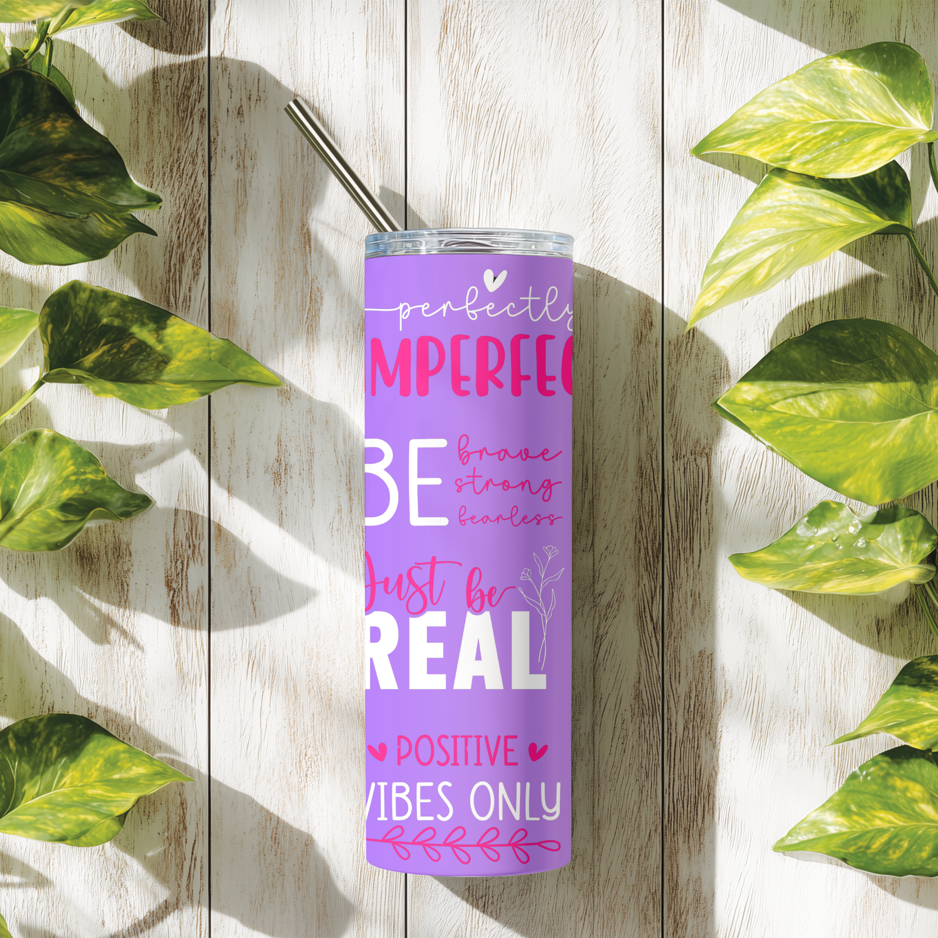 Perfectly Imperfect tumbler shown in lifestyle setting with greenery, inspirational stainless steel drinkware mockup.