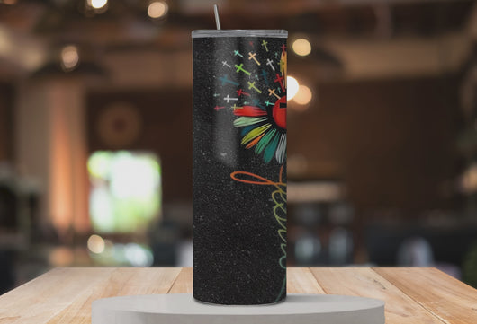Rotating mockup of Bloom in Faith™ tumbler showing all sides of the colorful flower and cross design.